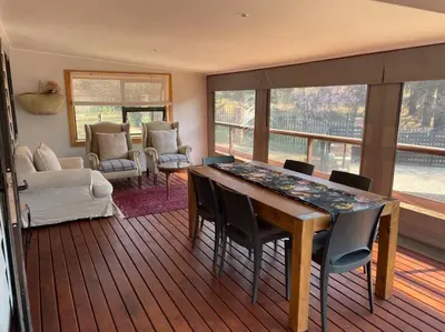 a living room with a table and chairs at Idlewood Unit 1 in Dullstroom