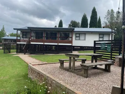 a house with a picnic table in front of it at Idlewood Unit 1 in Dullstroom