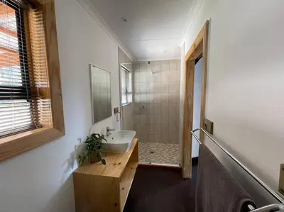 a bathroom with a sink and a shower at Idlewood Unit 1 in Dullstroom