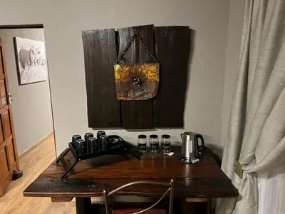 a wooden table with a coffee maker on a wall at 72 on Devenish in Polokwane