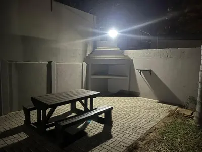 a bench sitting in front of a building with a light at 72 on Devenish in Polokwane