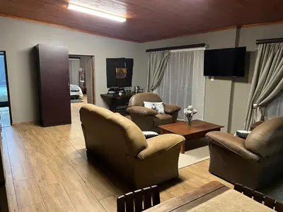 a living room with two chairs and a table at 72 on Devenish in Polokwane