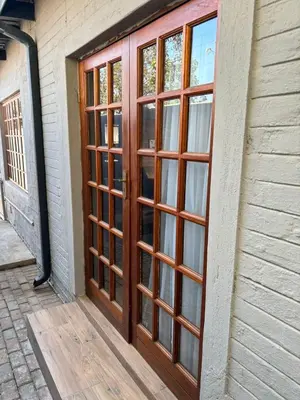 a wooden door with windows on the side of a building at 72 on Devenish in Polokwane
