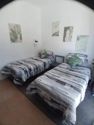 two beds sitting next to each other in a room at The Garden Cottage in Polokwane