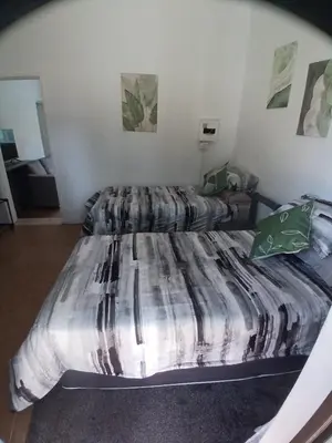 a bedroom with two beds in a room at The Garden Cottage in Polokwane