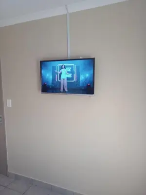 a television on a wall in a room at Tranquil heights Inn in Centurion