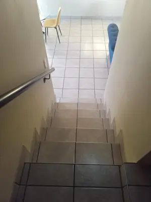 a staircase in a room with a tile floor at Tranquil heights Inn in Centurion