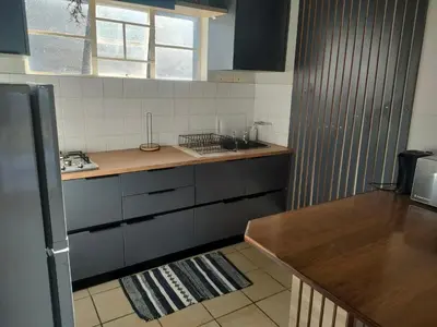 a kitchen with a sink and a counter top at Panaroma View in Graskop