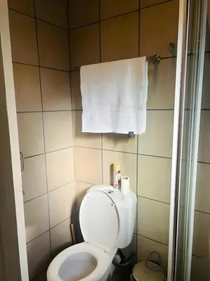 a bathroom with a toilet and a towel at Panaroma View in Graskop