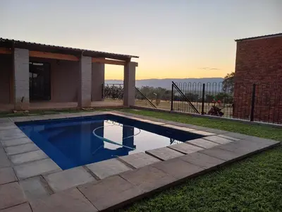 a swimming pool in the backyard of a house at At Skywalkers in Skeerpoort