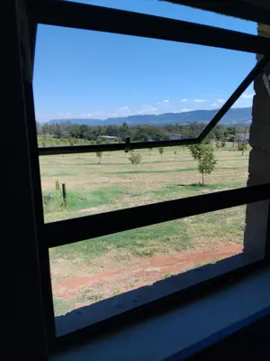 a view of a field from a window at At Skywalkers in Skeerpoort