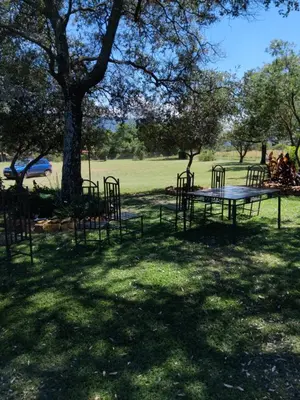 a park with tables and chairs in the grass at At Skywalkers in Skeerpoort