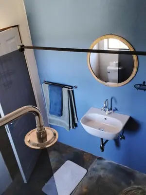 a bathroom with a sink and a mirror at At Skywalkers in Skeerpoort