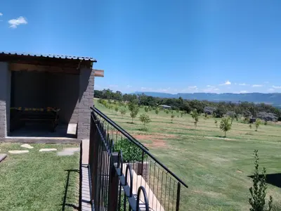 a balcony of a house with a view of a field at At Skywalkers in Skeerpoort