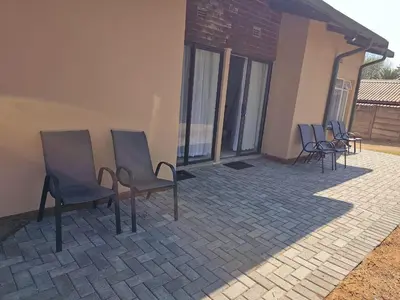 a group of chairs sitting on a patio at Protea Guesthouse in Middelburg