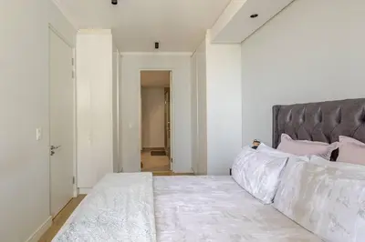 a bedroom with a large bed with pink pillows at Shapz at Ellipse-Waterfall in Midrand