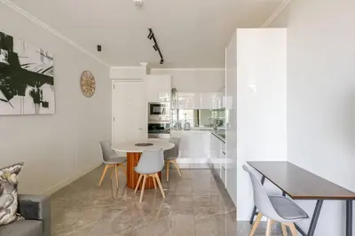 a kitchen and dining room with a table and chairs at Shapz at Ellipse-Waterfall in Midrand