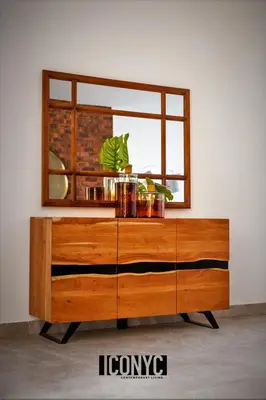a wooden dresser with a mirror on top of it at Iconyc Apartment in Brentwood Park