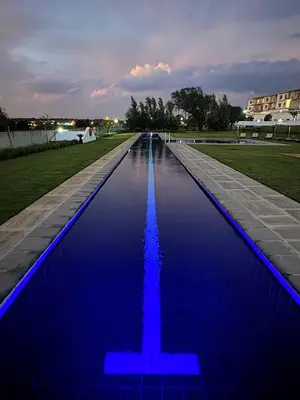 a swimming pool with blue lighting in a park at Iconyc Apartment in Brentwood Park