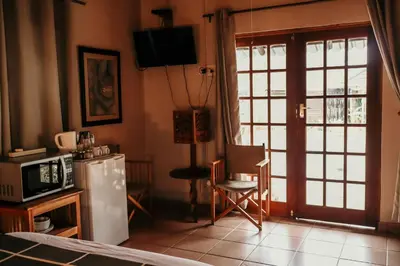 a kitchen with a refrigerator and a microwave at A Traveller's Palm in Phalaborwa