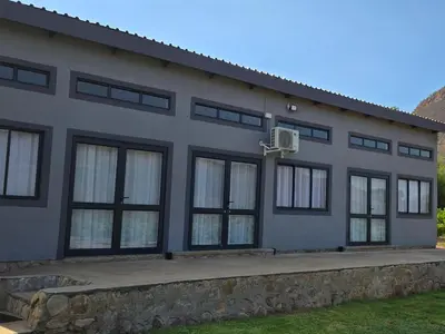 a house with a basketball hoop on the side of it at Die Boom Guest Farm in Boerboomskraal