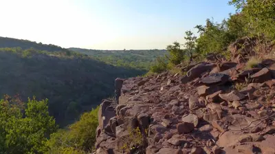 a large rocky hill with trees on it at Modubu Lodge in Bela-Bela