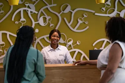a woman standing at a counter talking to two women at aha Skukuza Safari Lodge in Skukuza