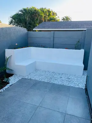 a white bench sitting on the side of a building at Tranquil Unit in Phalaborwa