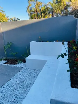 a garden with white steps and a wall at Tranquil Unit in Phalaborwa