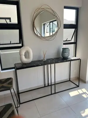 a room with a table with a mirror and vases on it at Irenes home of nature in Nelspruit