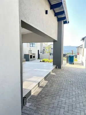 an outside view of a building with a brick sidewalk at Irenes home of nature in Nelspruit