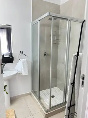 a shower stall in a bathroom with a sink at Irenes home of nature in Nelspruit