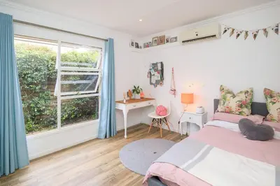 a bedroom with a bed and a desk and a window at Lovely Family Home in Pecanwood Golf Estate in Kosmos