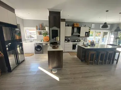 a large kitchen with a large island in the middle at Lovely Family Home in Pecanwood Golf Estate in Kosmos