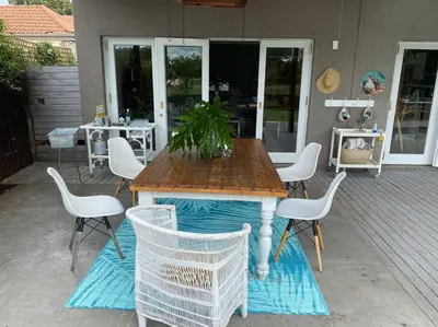 a wooden table and chairs on a patio at Lovely Family Home in Pecanwood Golf Estate in Kosmos