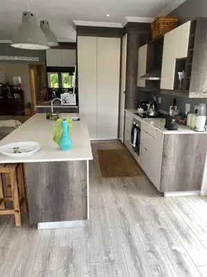 a kitchen with a counter with a blue vase on it at Lovely Family Home in Pecanwood Golf Estate in Kosmos