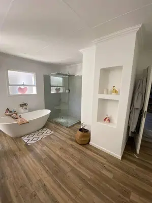a bathroom with a tub and a glass shower at Lovely Family Home in Pecanwood Golf Estate in Kosmos