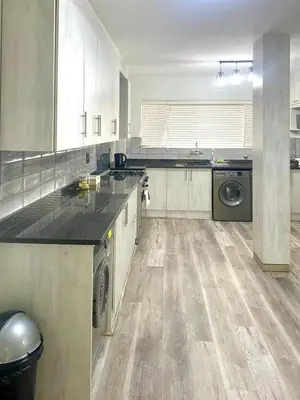 a large kitchen with a washer and dryer in it at Entire Apartment in Eldoraigne, Centurion in Eldoraigne