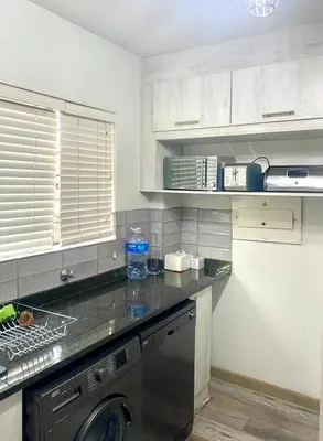 a kitchen with a washing machine on a counter at Entire Apartment in Eldoraigne, Centurion in Eldoraigne