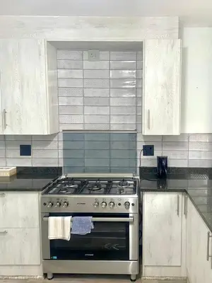 a kitchen with a stainless steel stove and white cabinets at Entire Apartment in Eldoraigne, Centurion in Eldoraigne