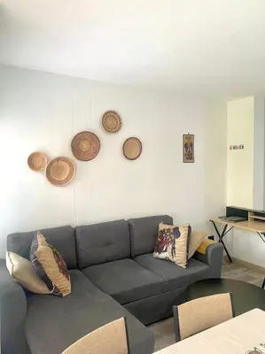 a living room with a couch and some plates on the wall at Entire Apartment in Eldoraigne, Centurion in Eldoraigne