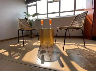 two chairs and a vase with candles in a room at LA Montranquilo-Home of comfort in Pretoria