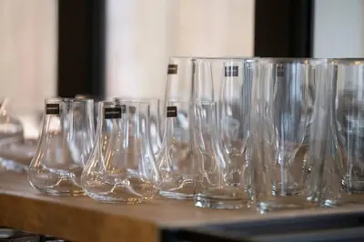 a row of empty wine glasses sitting on a table at Bateleur Kruger Lodge in Marloth Park