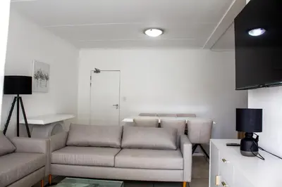 a living room with a couch and a table at Time Oon Travel & Tour The Blyde in Pretoria
