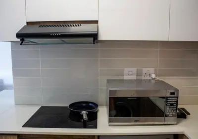 a kitchen with a microwave and a pot on a stove at Time Oon Travel & Tour The Blyde in Pretoria
