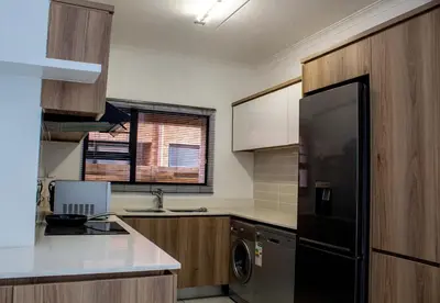a kitchen with a black refrigerator and a dishwasher at Time Oon Travel & Tour The Blyde in Pretoria