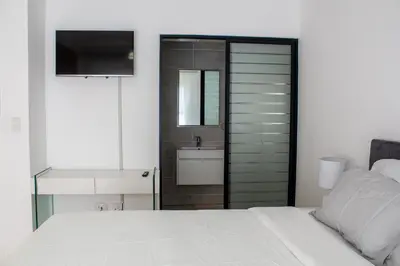 a bedroom with a white bed and a sink at Time Oon Travel & Tour The Blyde in Pretoria