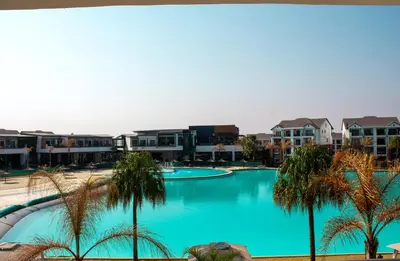 a view of a swimming pool with palm trees at Time Oon Travel & Tour The Blyde in Pretoria