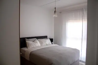 a white bedroom with a bed and a window at Time Oon Travel & Tour The Blyde in Pretoria