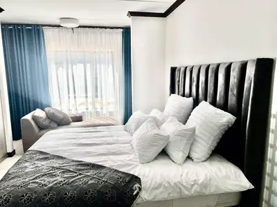 a bedroom with a large bed with white pillows at Euoren Living in Midrand